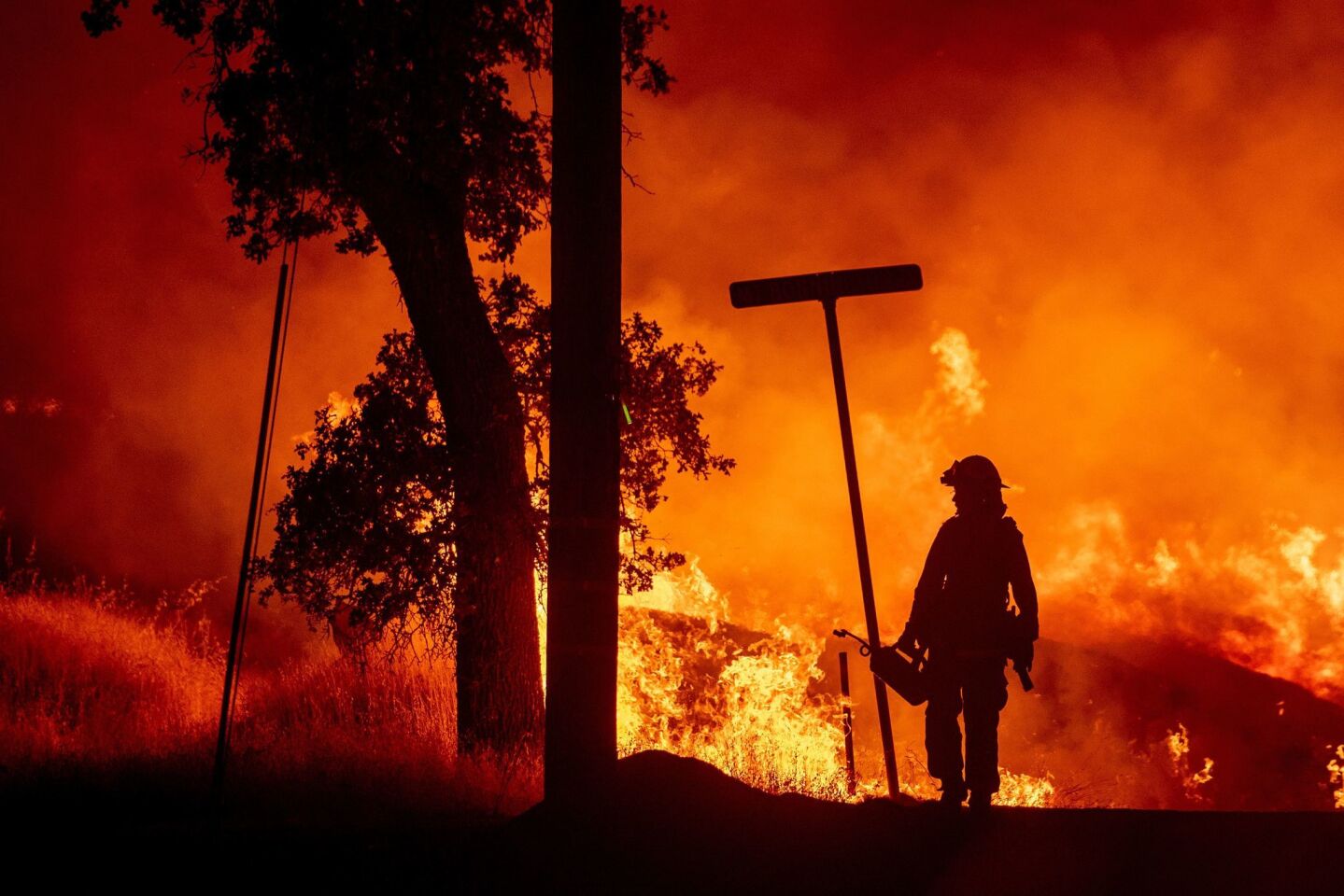 A firefighter lights backfires during the Carr fire near Redding on July 27.