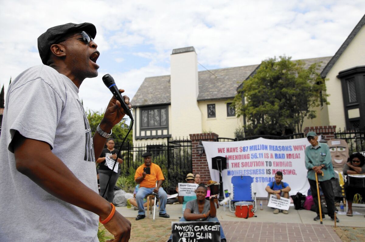 Pete White of the Los Angeles Community Action Network speaks during a demonstration Thursday in front of Mayor Eric Garcetti's residence over measures targeting homeless encampments.