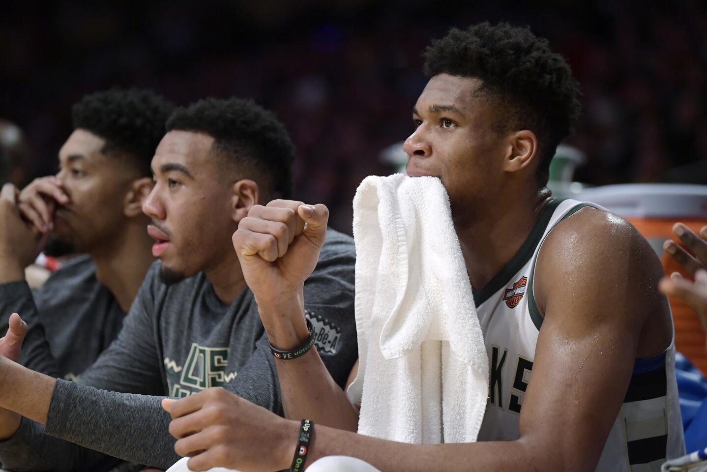 Milwaukee Bucks forward Giannis Antetokounmpo, right, celebrates from the bench after the Bucks scored during the second half of an NBA basketball game against the Los Angeles Lakers on Friday, March 1, 2019, in Los Angeles. The Bucks won 131-120. (AP Photo/Mark J. Terrill)