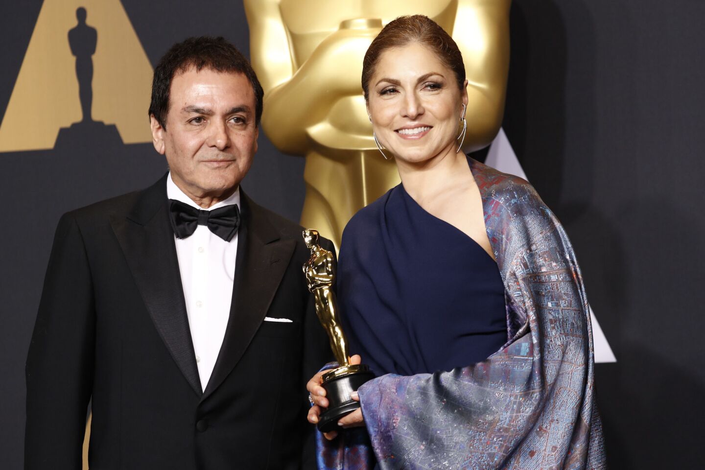 Engineer and astronaut Anousheh Ansari, right, and former NASA scientist Firouz Naderi with the award for best foreign language film for "The Salesman." They accepted on behalf of director Asghar Farhadi.