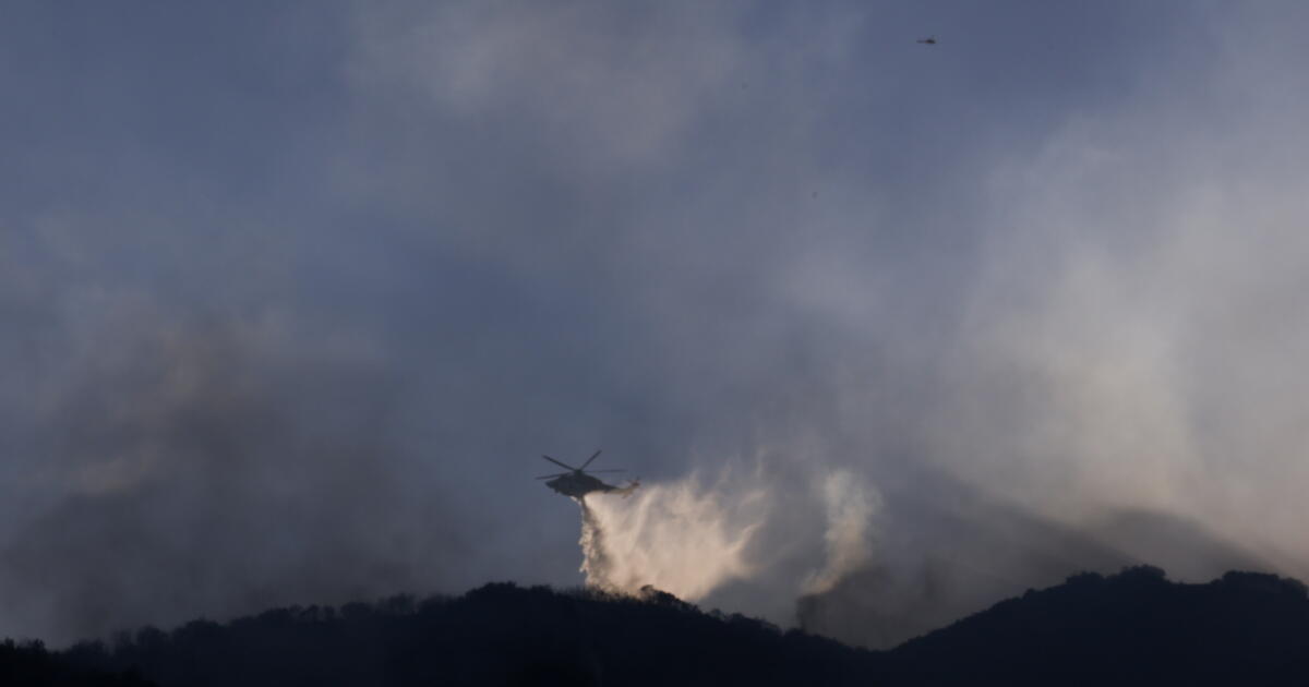 Photo: latimes.com LOS ANGELES, CA - SEPTEMBER 09: Helicopters fly by to fight a brush fire off the 405 burns near the Getty Center has grown