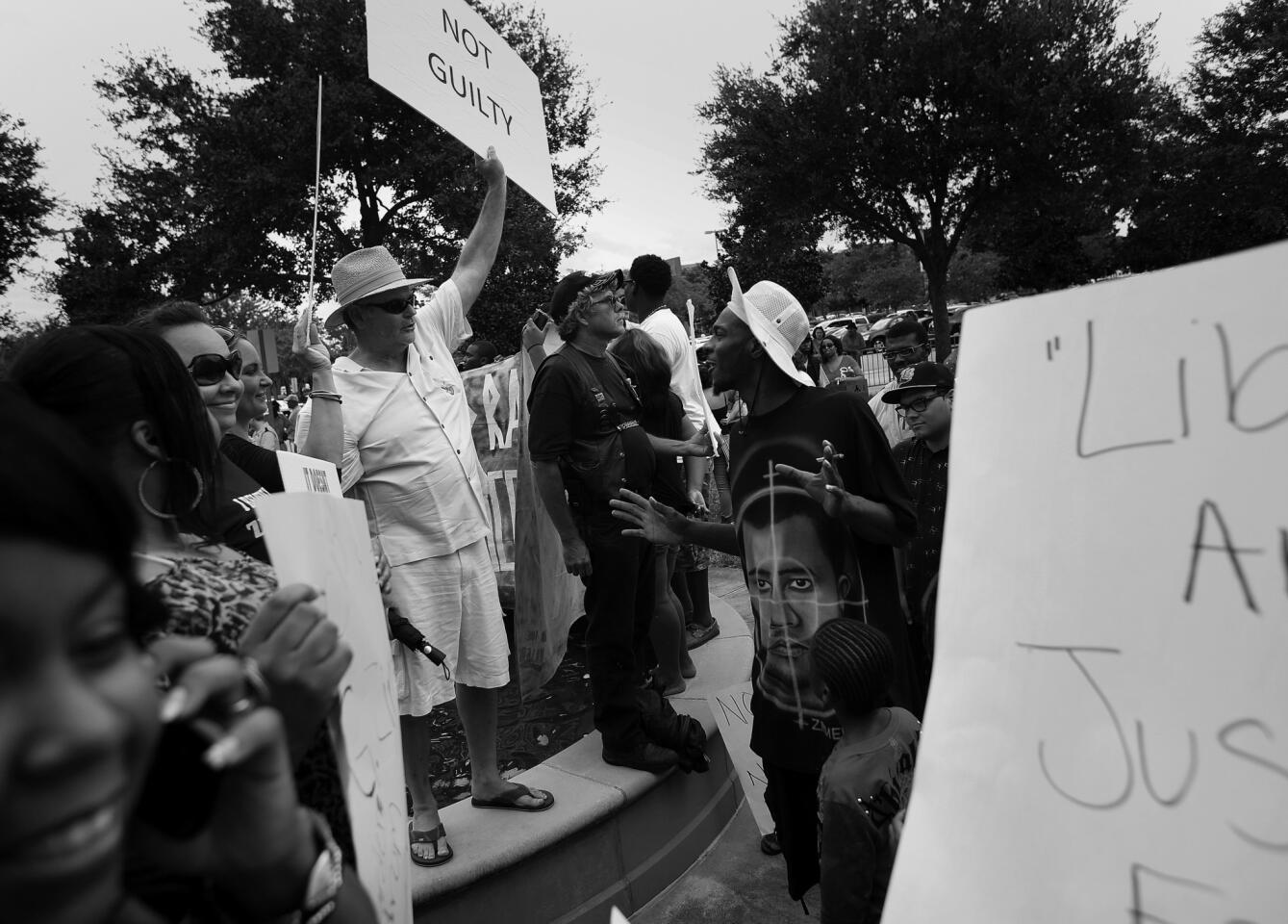 Protesters from both sides gather outside of the Seminole County Criminal Justice Center on Saturday, July 13, 2013. George Zimmerman is charged with 2nd-degree murder in the fatal shooting of Trayvon Martin, an unarmed teen, in 2012.