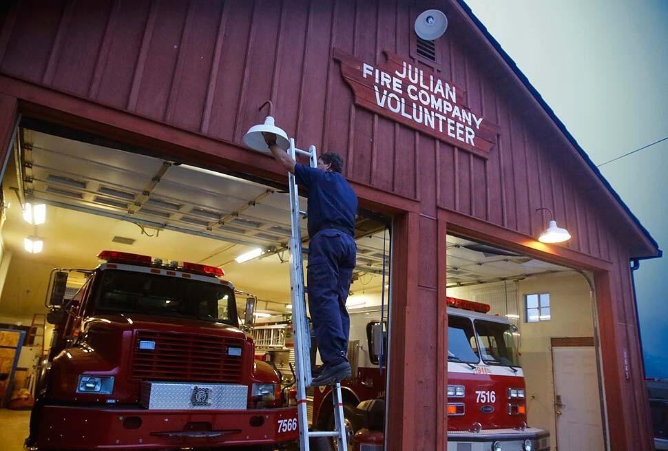 Engineer Brian Crouch checks a light bulb at the Julian fire station in the San Diego County mountain town.