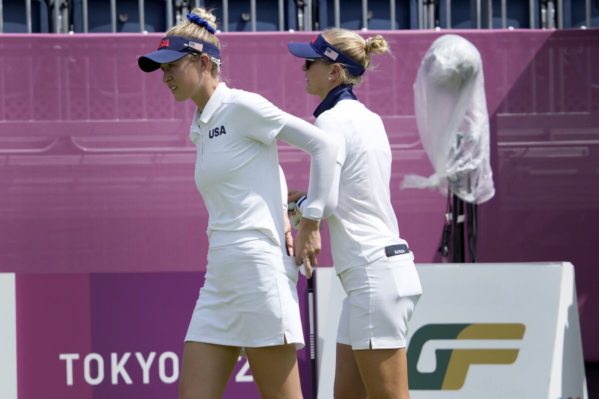 Nelly Korda, of the United States, right, and her sister, Jessica Korda, of the United States, prepare to play a practice round prior to the women's golf event at the 2020 Summer Olympics, Monday, Aug. 2, 2021, at the Kasumigaseki Country Club in Kawagoe, Japan, (AP Photo/Andy Wong)