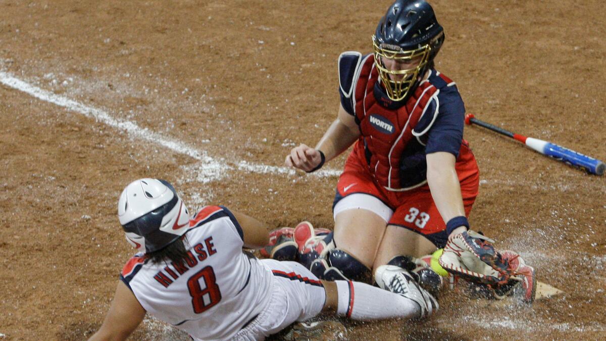 Japan's Megu Hirose scores as U.S. catcher Stacey Nuveman tries to apply the tag during the 2008 Beijing Olympics.