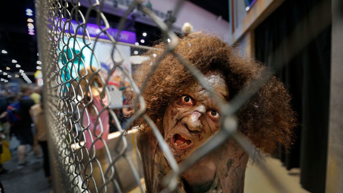 A zombie actor from the AMC series "The Walking Dead" approaches visitors at Comic-Con International 2017 in San Diego.