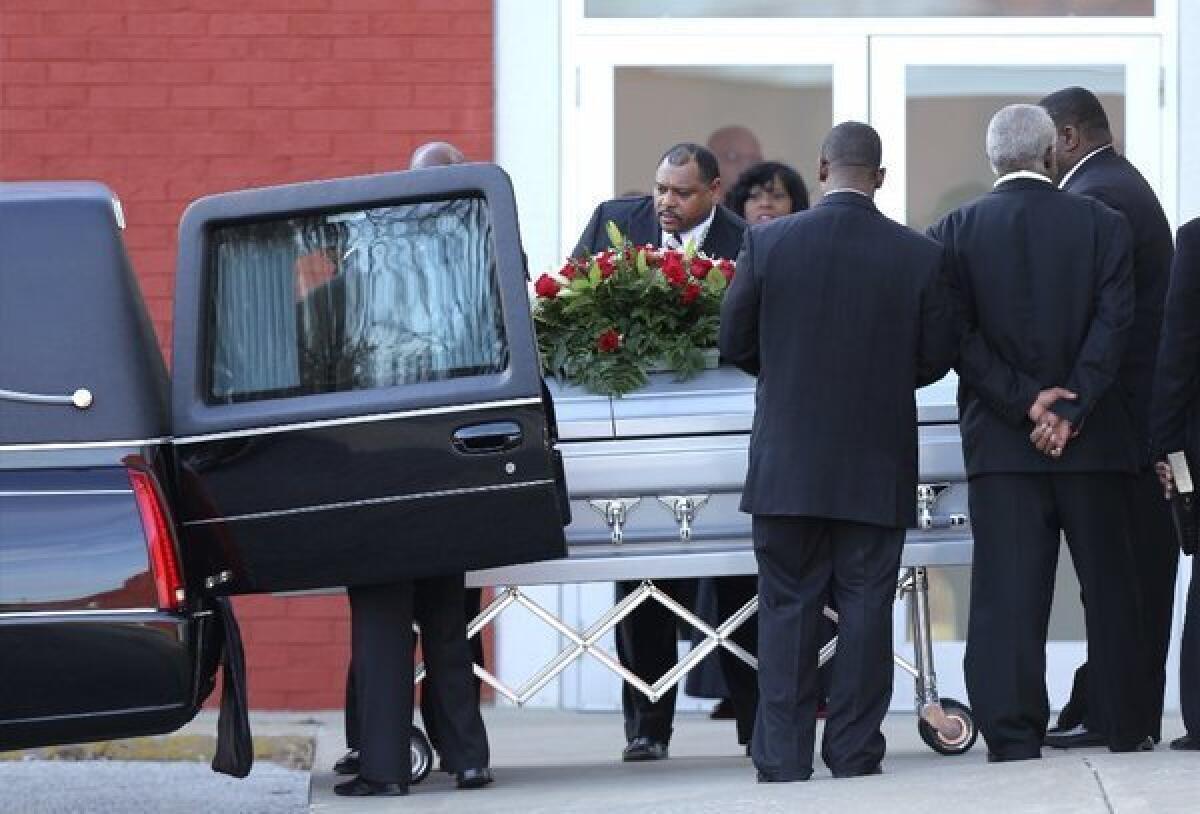 Pallbearers place a coffin with the body of Kansas City Chiefs linebacker Jovan Belcher into a hearse Wednesday.