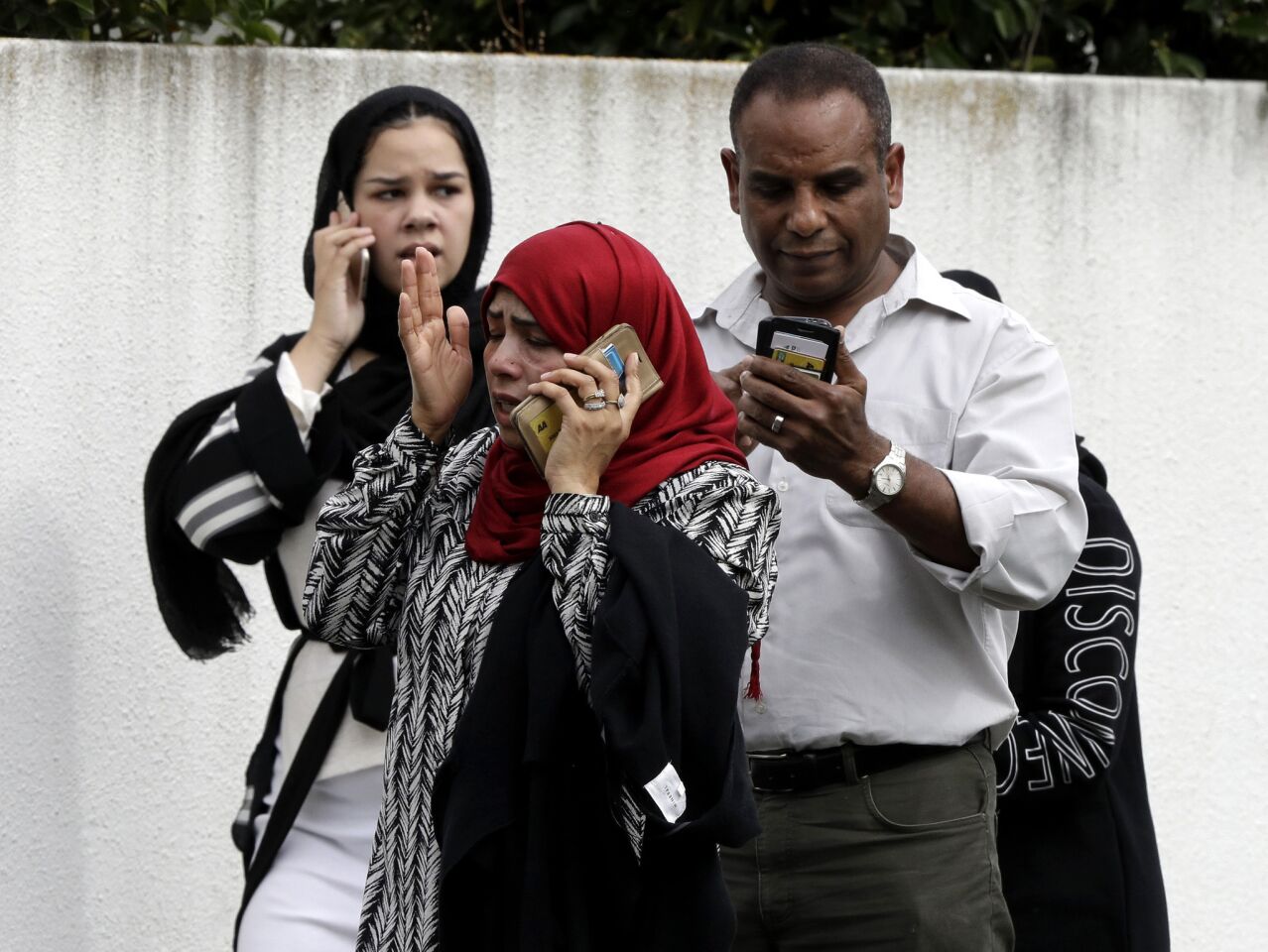 People wait for news outside a mosque in central Christchurch after the shootings.