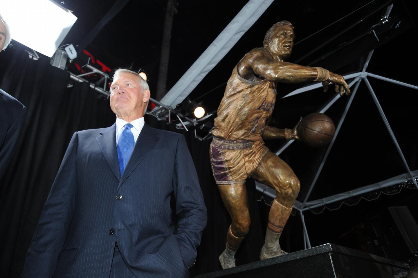 Jerry West stands next to his Staples Center statue during its unveiling on Feb. 17, 2011.