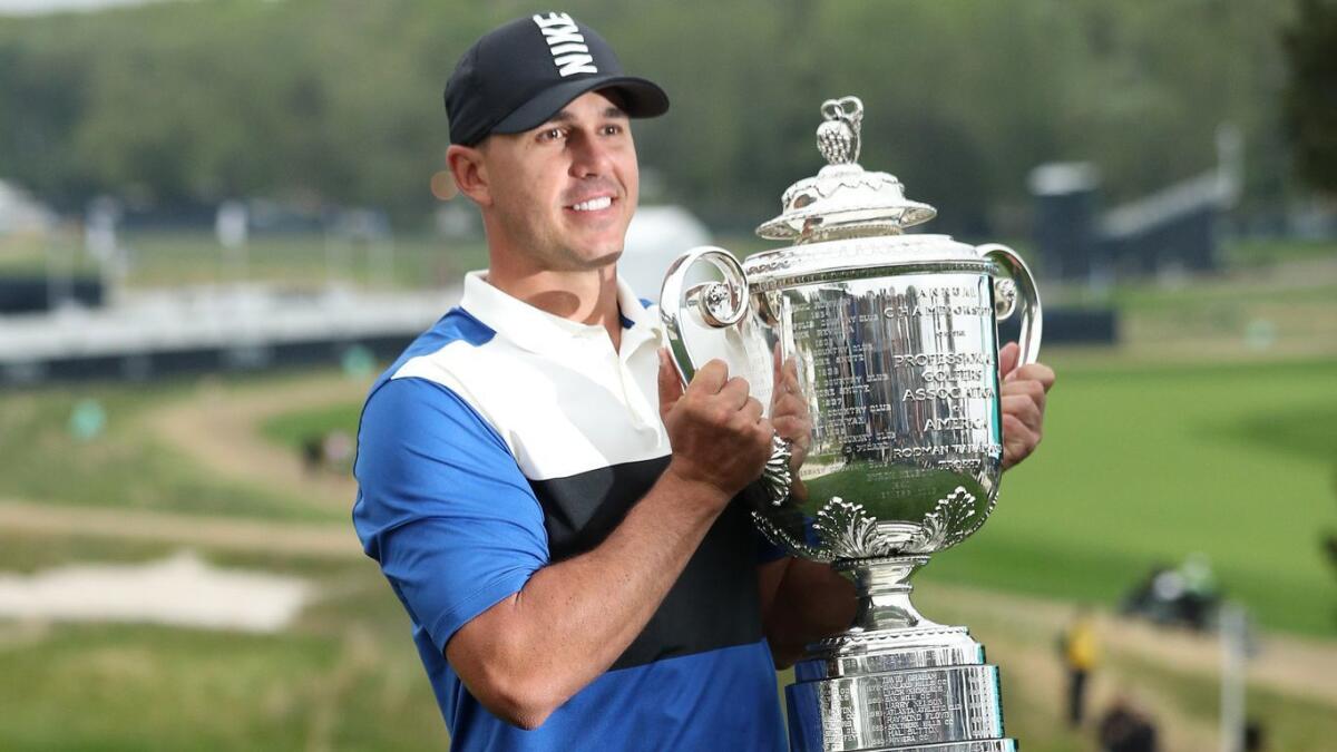 Brooks Koepka poses with the Wanamaker Trophy after winning the PGA Championship on May 19.