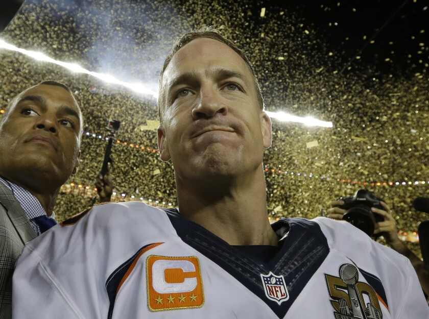 Chad Steele, left, leads Peyton Manning through the field after Super Bowl 50.