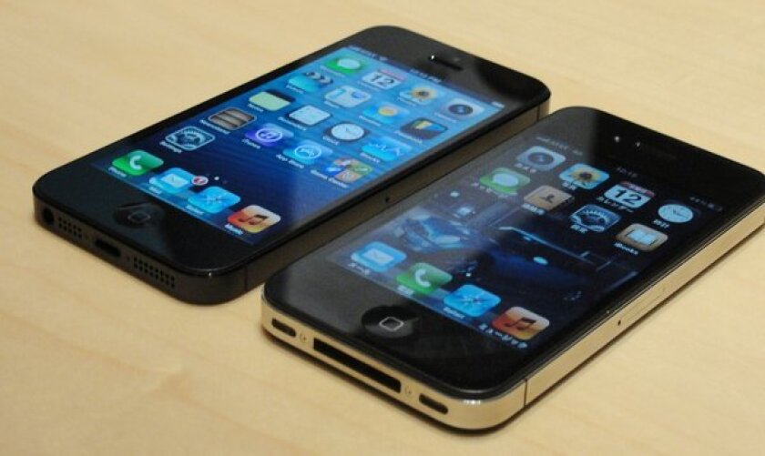 Apple's 4-inch screen iPhone 5, left, and the 3.5-inch screen iPhone 4S.