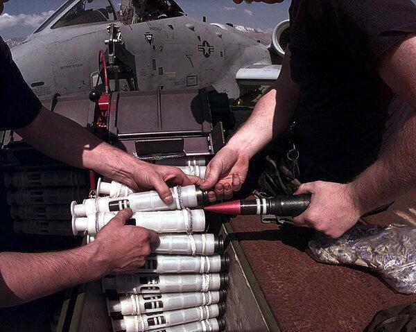 U.S. Air Force airmen prepare to reload the 30-millimeter cannon of an A-10 plane with ammunition at an air base in Italy in 1999.
