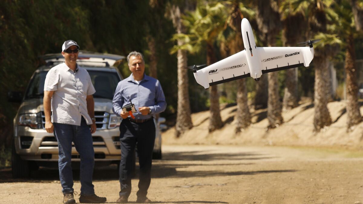 AeroVironment Chief Executive Wahid Nawabi, right, pilots the company's Quantix drone in July.