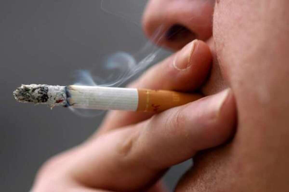A person smokes a cigarette.