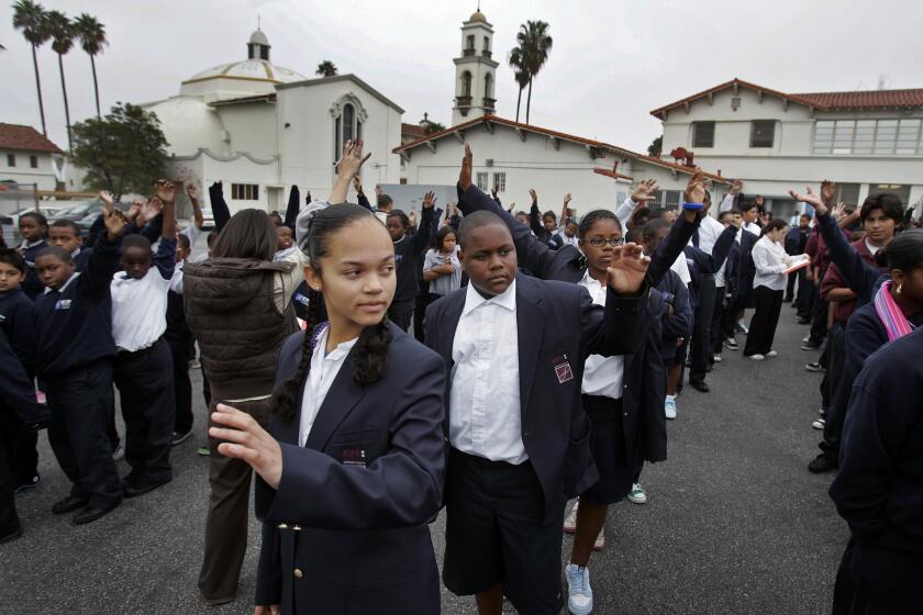 Students participate in an assembly at Kipp Academy of Opportunity, which is part of a group of charter schools that plans a major expansion in Los Angeles.