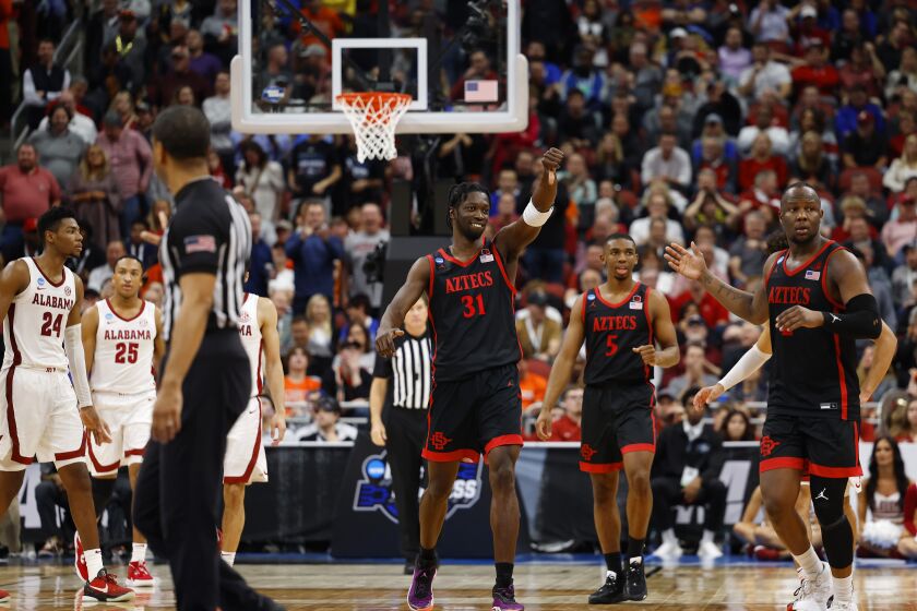 Louisville, KY - March 24: San Diego State's Nathan Mensah (31) celebrates during a win against Alabama in a Sweet 16 game in the NCAA Tournament on Friday, March 24, 2023 in in Louisville, KY. (K.C. Alfred / The San Diego Union-Tribune)