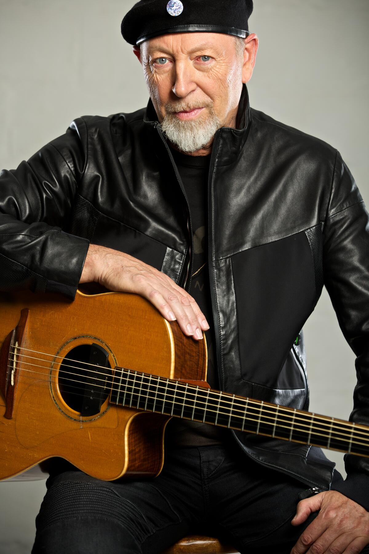 Richard Thompson holds a guitar