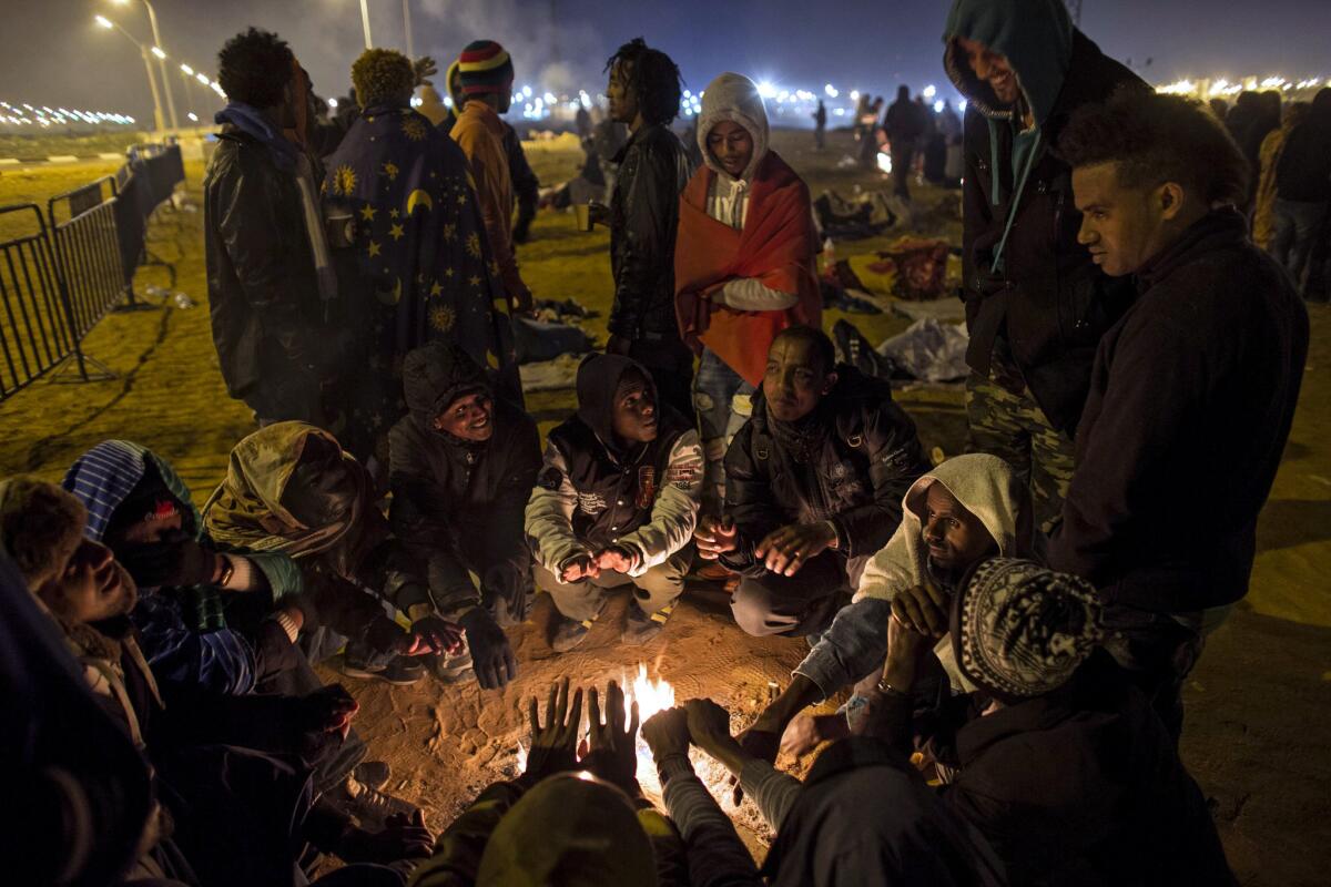 African asylum seekers gather around a fire outside the Holot detention center. Several hundred took part in the February protest against the opening of the center and against Israel's refusal to grant them asylum.