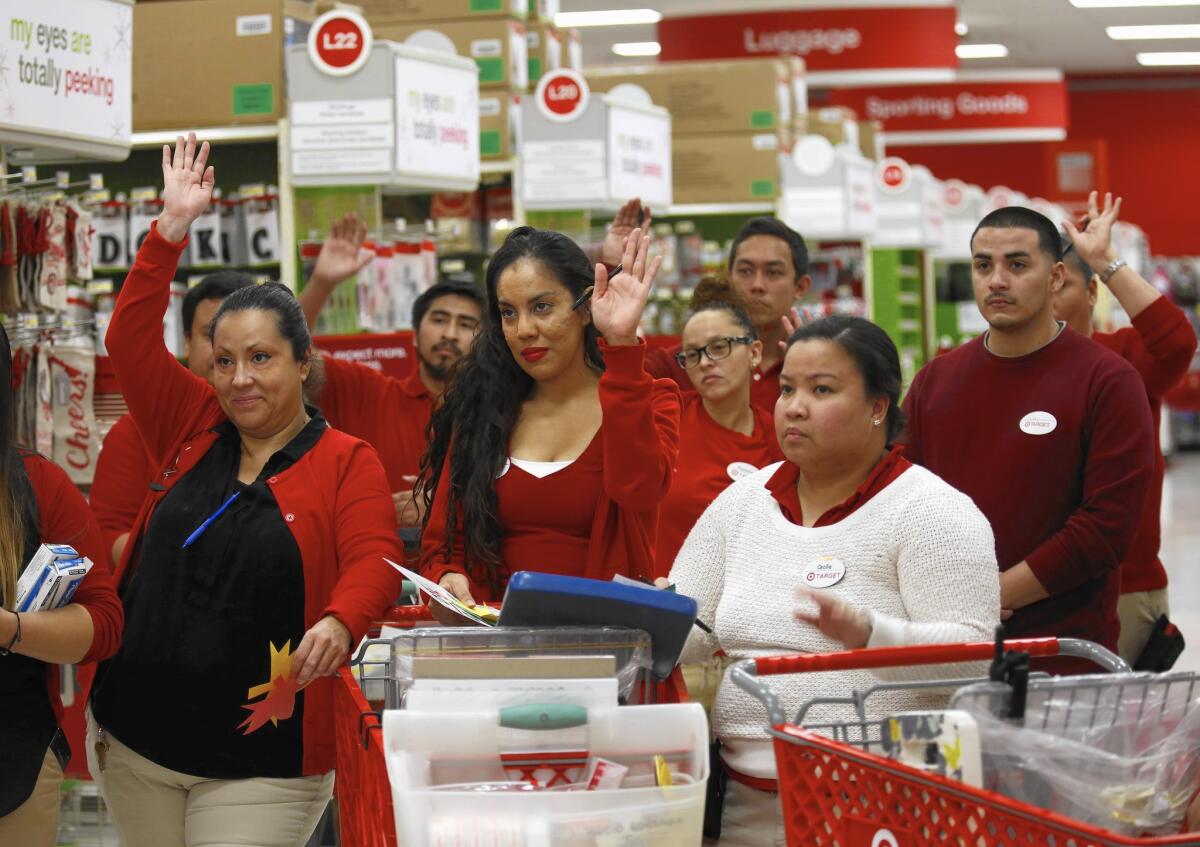 Workers gather for a meeting in preparation for Black Friday at a Target store in Eagle Rock.