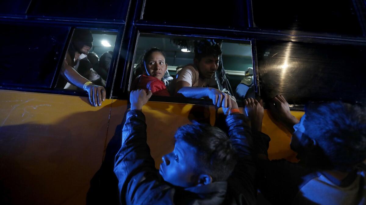 A busload of Central American immigrants arrives at the Benito Juarez sports facility on Nov. 16, 2018.