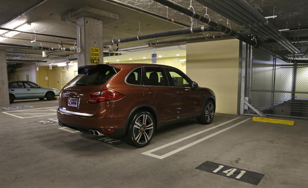 A Porsche SUV is parked in space No. 142 on Thursday in a parking lot near AT&T; Park in San Francisco. A spot in the city's trendy South Beach neighborhood sold last week for $82,000. The 8- by 12-foot parking space is in an enclosed garage in a condominium building.