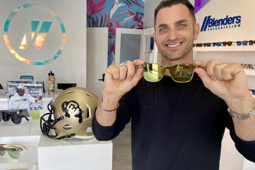 Blenders founder Chase Fisher shows a pair of Prime 21 sunglasses Tuesday at the company's headquarters in Pacific Beach.