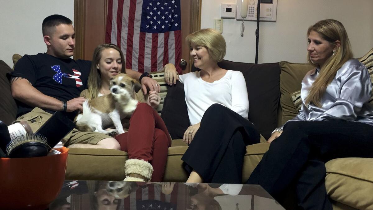 Raymond Royal, Chrissy Royal, Kathleen Stanfield and Karen Anderson sit in the Royals' Seoul apartment after Raymond Royal's two-day preliminary hearing.