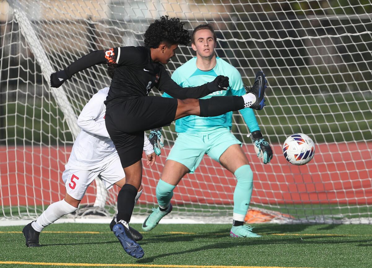 Los Amigos' Jason Marin (9) just misses a shot in front of goalie Tait Whittemore against Redlands East Valley.