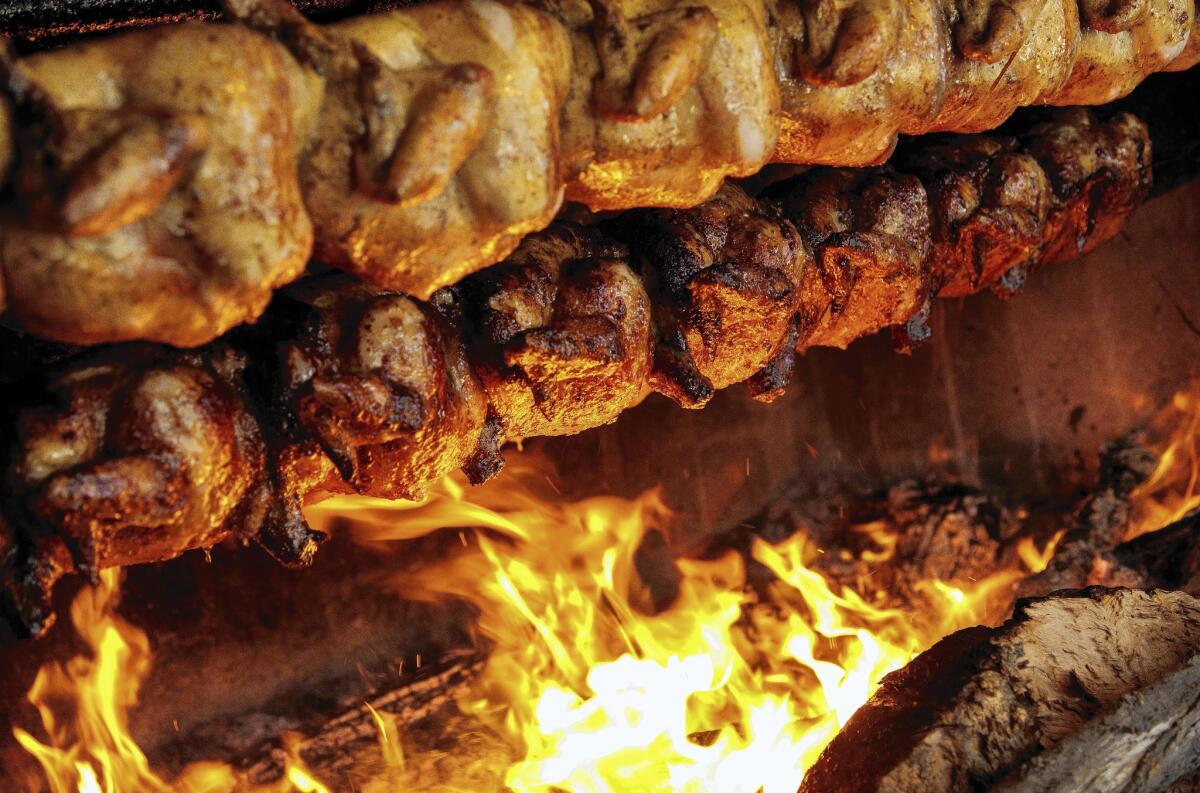 Rotisserie chicken is kissed by flames at Pollo a la Brasa.