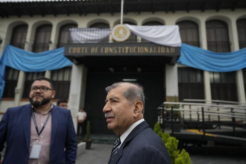 Supreme Electoral Tribunal's Mynor Franco, center, arrives to the Constitutional Court building in Guatemala City, Friday, Sept. 29, 2023. The prosecutor's office raided the electoral tribunal for the fourth time on Friday in search of election results records following Bernardo Arévalo's presidential election win. (AP Photo/Moises Castillo)