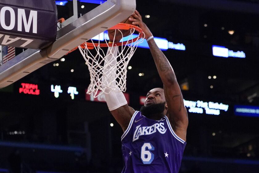 Los Angeles Lakers forward LeBron James (6) dunks the ball during the first half.