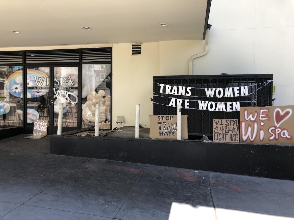 One of the signs outside of Wi Spa in Koreatown on Saturday says: "Trans women are women."