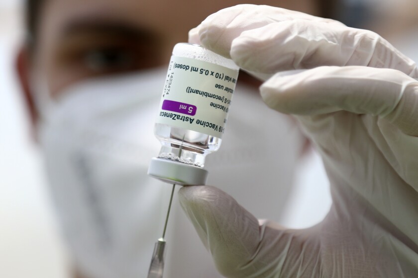 Closeup of a syringe being filled with AstraZeneca vaccine.