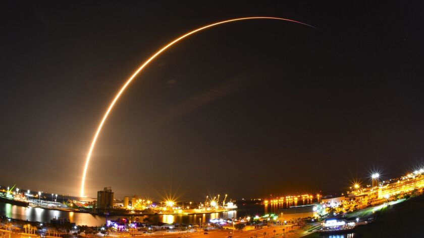 A SpaceX Falcon 9 rocket launches a commercial communications satellite in July 2018 from Cape Canaveral Air Force Station in Florida.