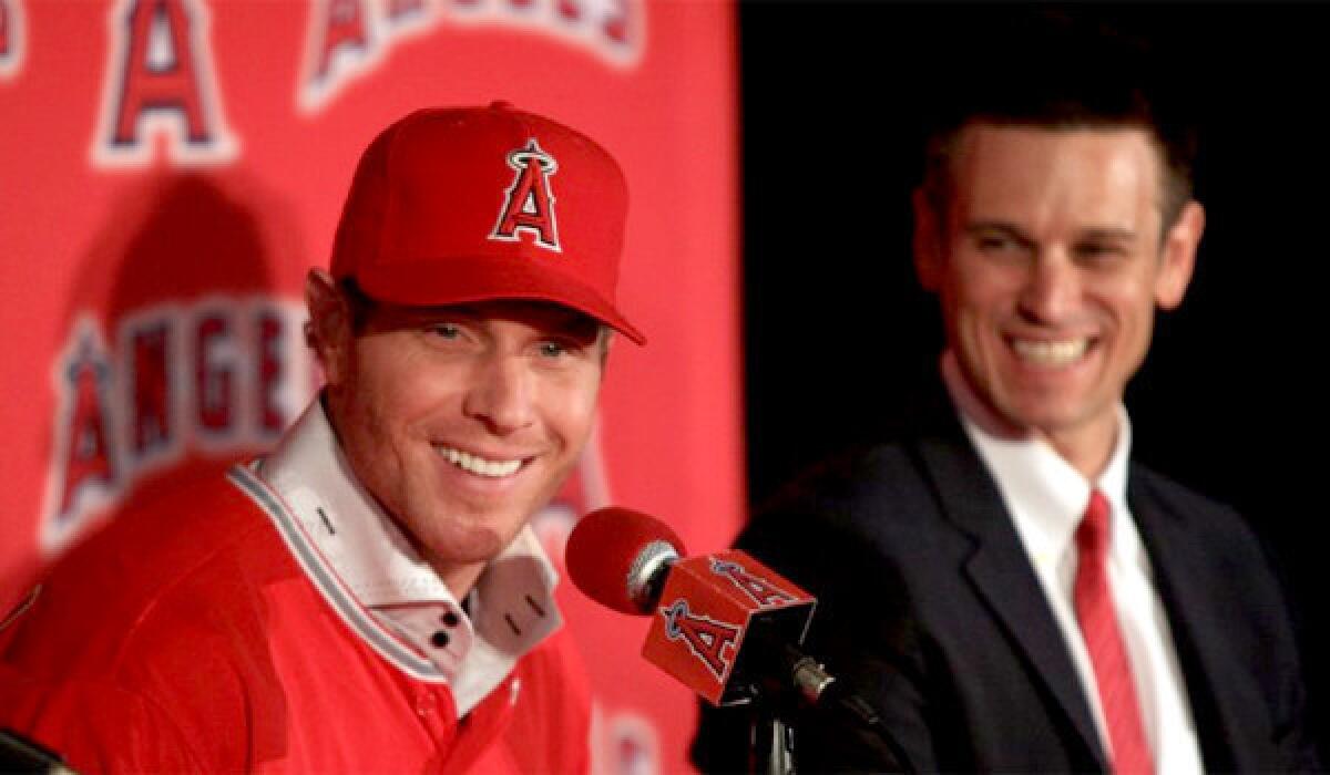 Angels General Manager Jerry Dipoto, right, says he thinks Josh Hamilton, left, who is hitting .214 with 10 home runs and 26 runs batted in, will overcome his struggles at the plate.