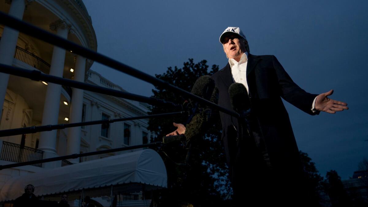 President Donald Trump speaks to members of the media on the South Lawn at the White House in Washington on Dec. 17.