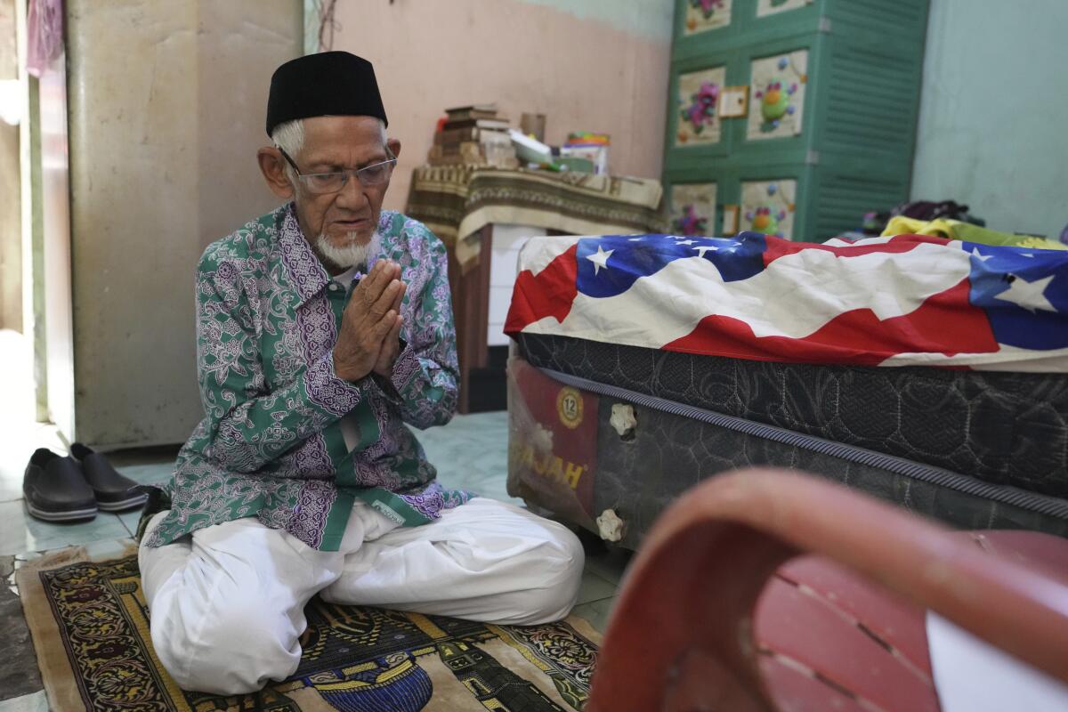 Husin bin Nisan prays at his home in Tangerang, Indonesia.