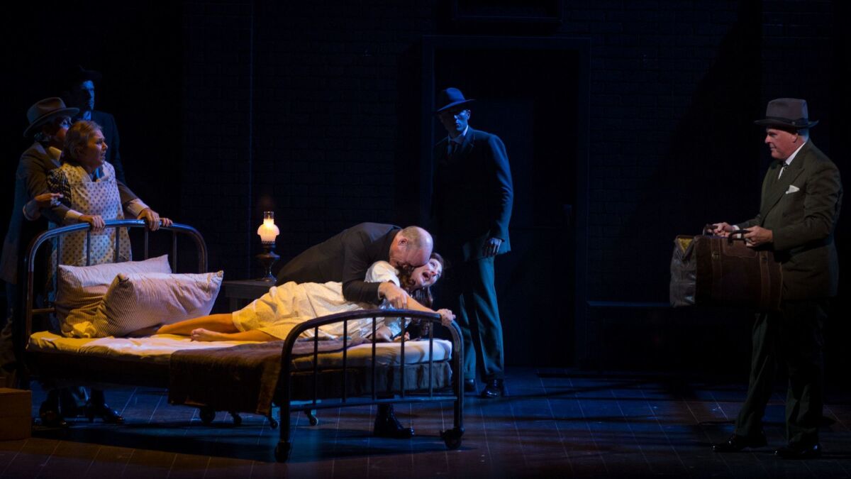 Carmen Cusack as Alice Murphy on the bed, with Stephen Lee Anderson playing her father in "Bright Star" at the Ahmanson.