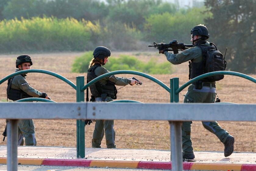 Members of the Israeli security forces secure an area near a checkpoint on the outskirts of Sderot on October 8, 2023. Israel, reeling from the deadliest attack on its territory in half a century, formally declared war on Hamas on October 8, as the conflict's death toll surged to 1,000 after the Palestinian militant group launched a massive surprise assault from Gaza. (Photo by JACK GUEZ / AFP) (Photo by JACK GUEZ/AFP via Getty Images)