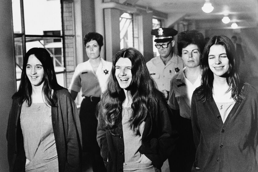 Three female defendants in the Sharon Tate murder trial burst out laughing as they come within range of news cameras en route to court in Los Angeles, Aug. 11, 1970. Left to right: Susan Denise Atkins, Patricia Krenwinkel, Leslie Van Houten. (AP Photo)