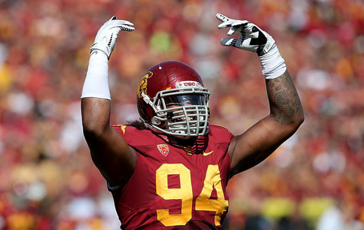 USC defensive end Leonard Williams tries to get the crowd to cheer during a game against Utah on Sept. 21.