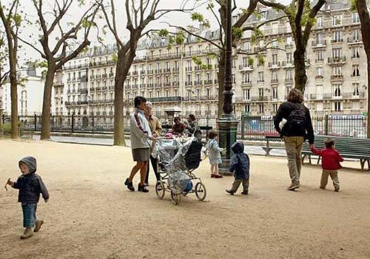 Paris can be family friendly. Parents and children amble in the Square des Batignolles.