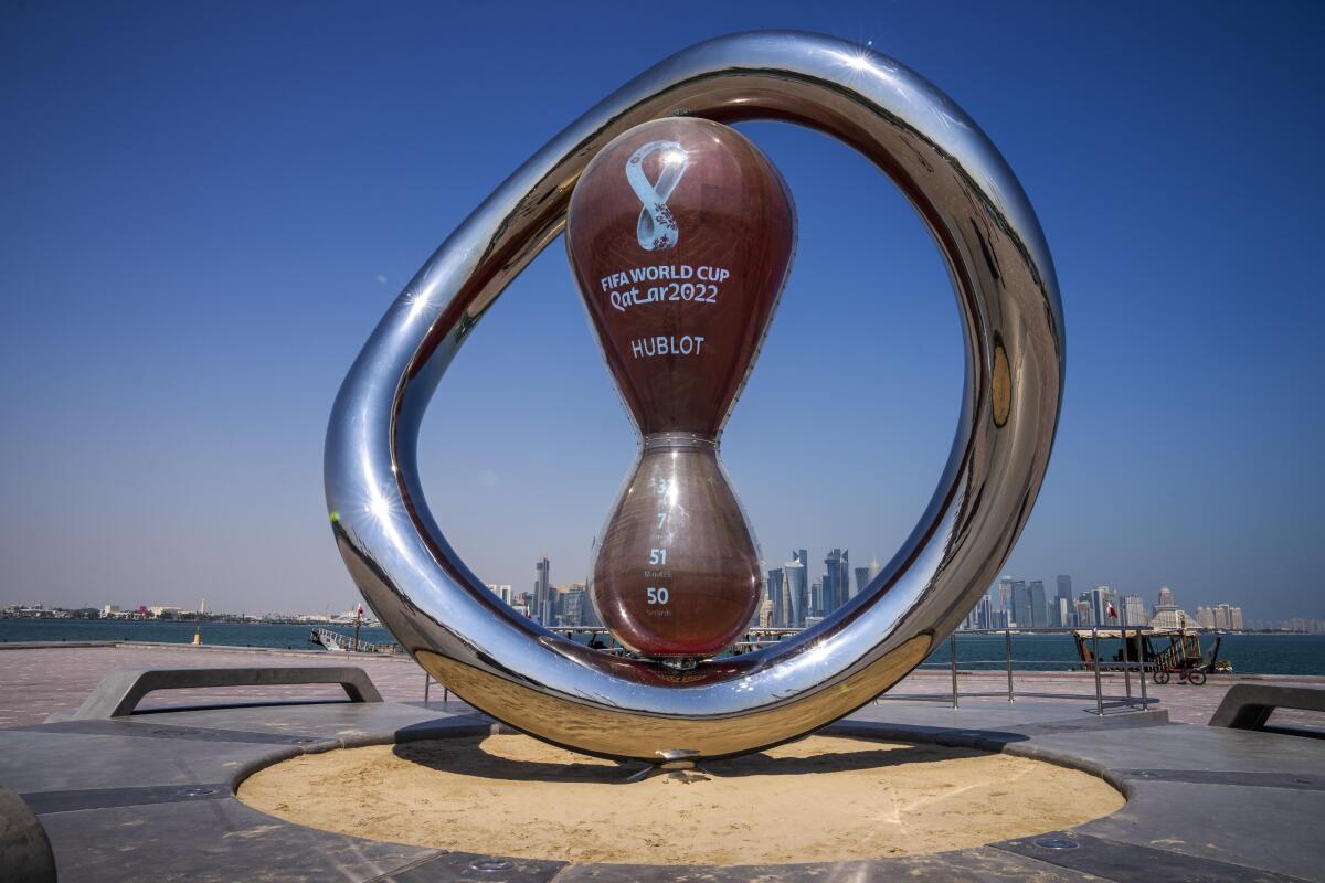 The official FIFA World Cup Countdown Clock on Doha's corniche, overlooking the skyline of Doha, Qatar, Wednesday, Oct. 19, 2022. One of the world’s biggest sporting events has thrown an uncomfortable spotlight on Qatar’s labor system, which links workers’ visas to employers and keeps wages low for workers toiling in difficult conditions. (AP Photo/Nariman El-Mofty)