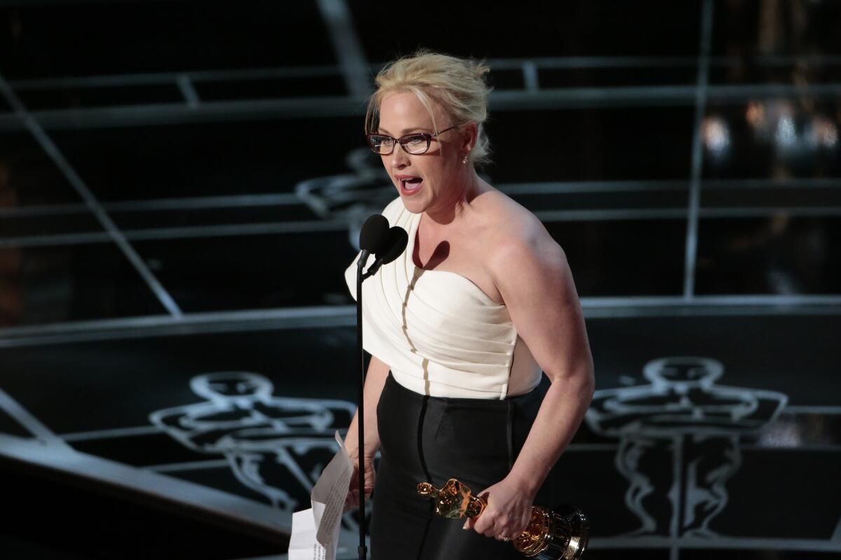 Patricia Arquette accepts the supporting actress Oscar for her role in "Boyhood" at the 87th Academy Awards.