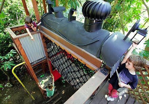 Ben Tzudiker, right, plays with friends on the train-treehouse designed by Peter Rader in Bens Nichols Canyon backyard.