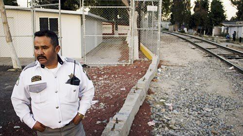 Officer Patricio Salgado Garcia watches over an empty safe house that was built for the many Central American migrants who pass through Ecatepec, a Mexico City suburb. The mayor has declared the city to be migrant friendly and has ordered police and city officials not to cooperate with Mexican immigration authorities.