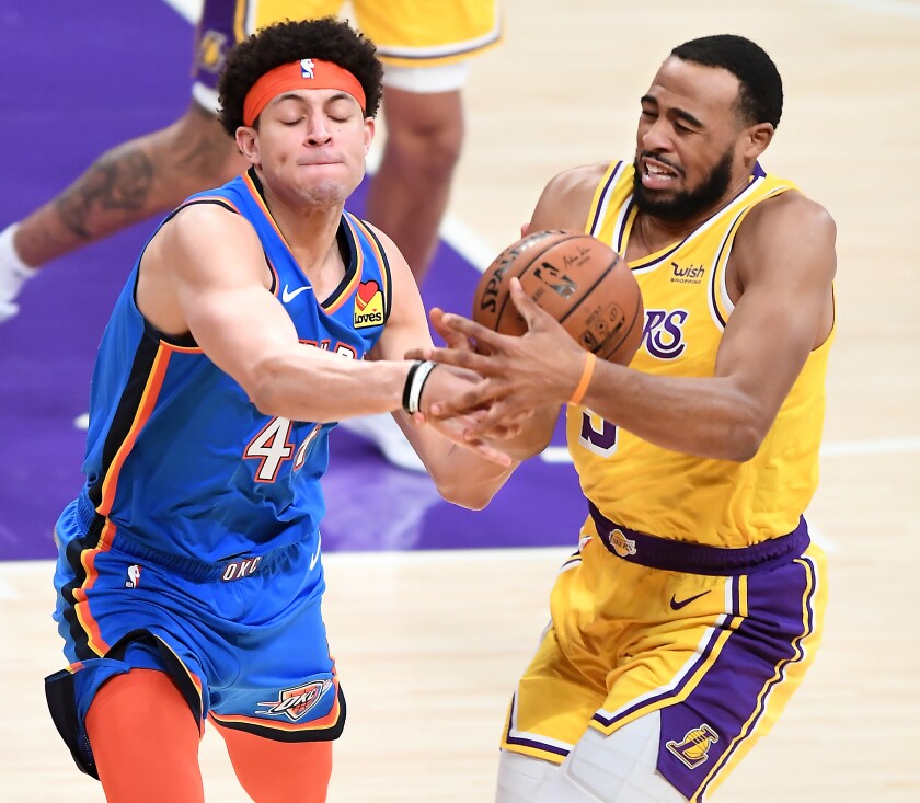 Lakers guard Talen Horton-Tucker and Thunder forward Justin Jackson battle for a loose ball.
