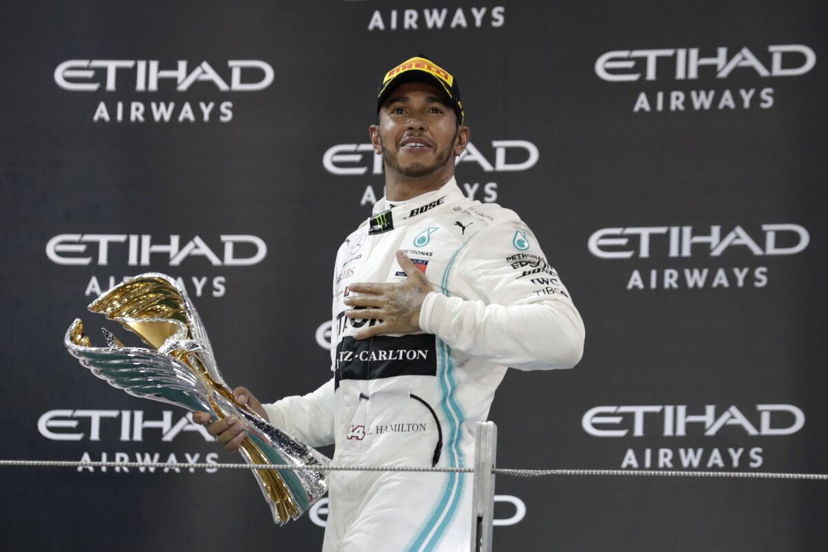 Lewis Hamilton of Britain celebrates on the podium after winning the Emirates Formula One Grand Prix at the Yas Marina racetrack in Abu Dhabi, United Arab Emirates on Dec.1. 