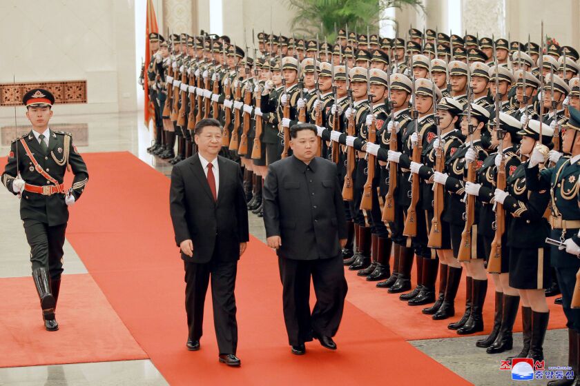 North Korean leader Kim Jong Un, right, and Chinese counterpart Xi Jinping inspect the honor guard at the Great Hall of the People in Beijing.